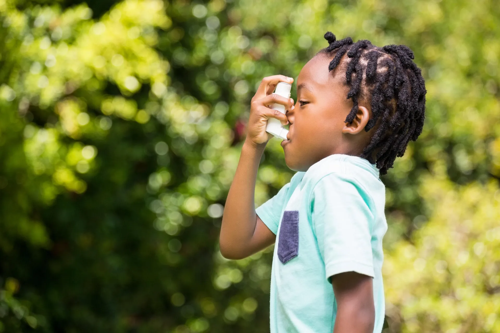 Child using an inhaler outdoors
